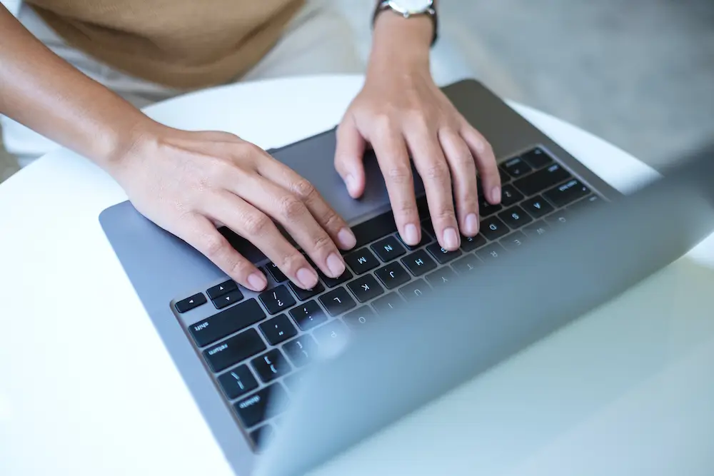 Top view of woman's hands working and typing